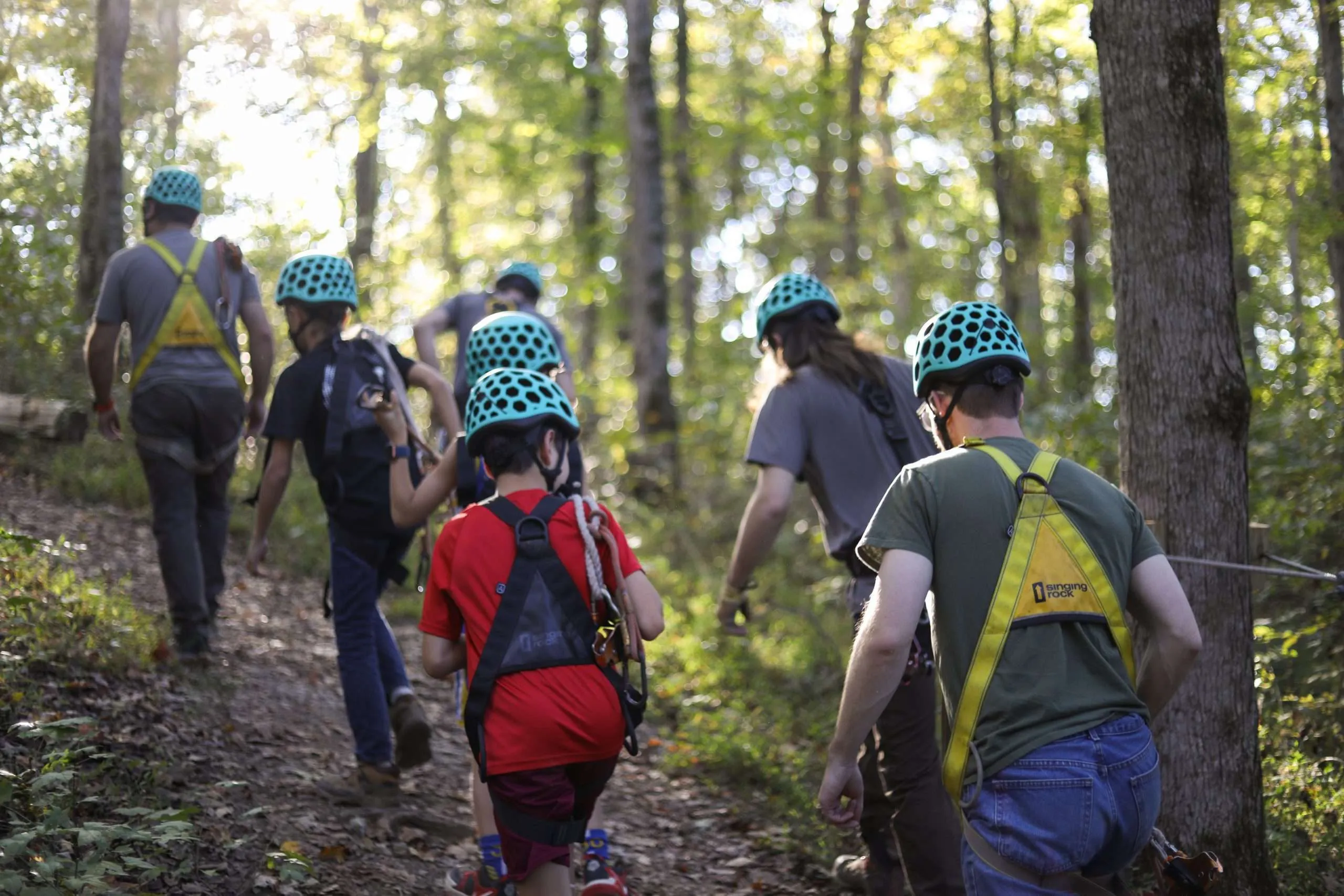 Group of participants hiking between zipline platforms in the forest at Adventureworks Nashville